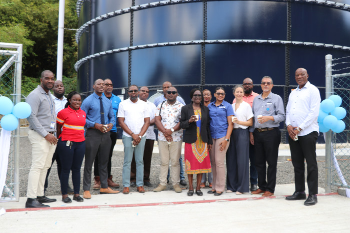 Project Engineers, NAWASA & GCREWS teams standing in front of 360,000 gallons water storage tank