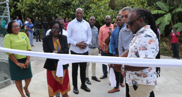  Parliamentary Representative cutting the ribbon to officially signal the commissioning of Tufton Hall Water Storage Tank. 